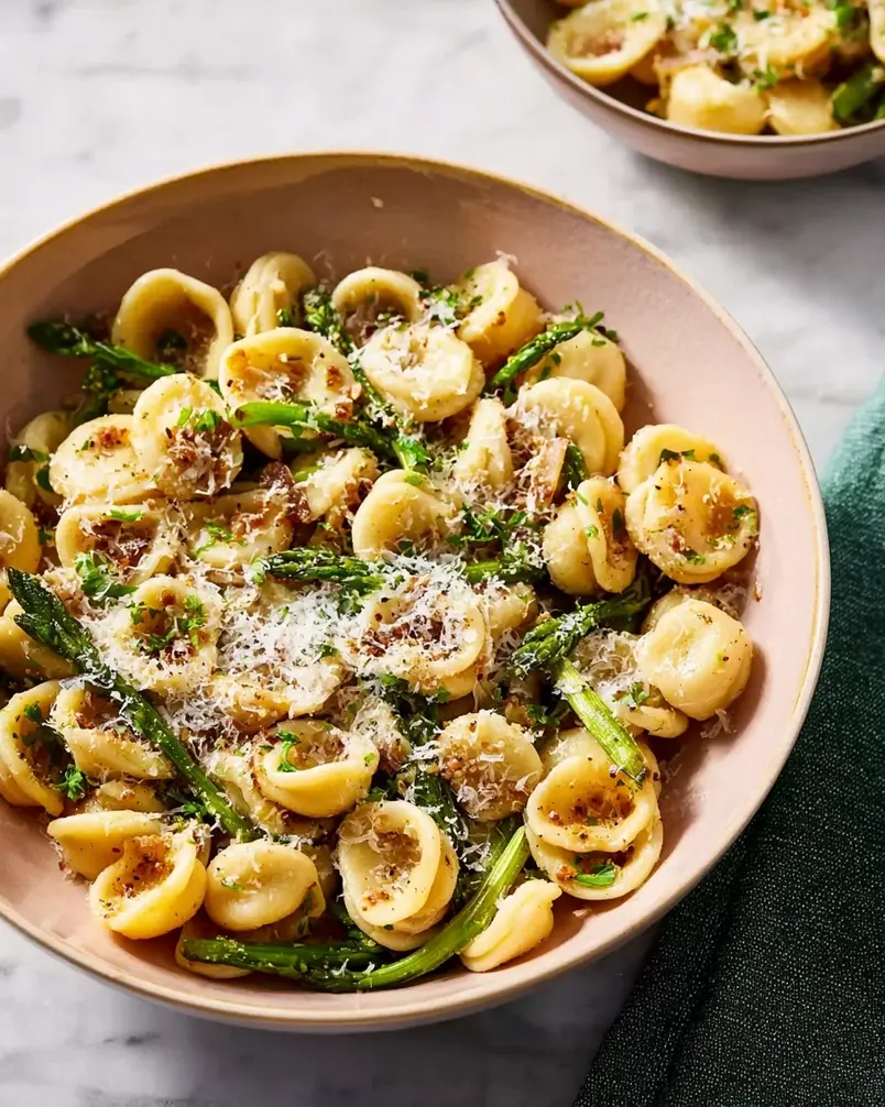One Pan Orecchiette Pasta 2 A close-up shot of orecchiette pasta being tossed with vibrant vegetables and sauce in a single pan, showcasing the ease of the one-pan cooking method.